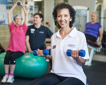 Accredited exercise physiologist instructing a cancer survivor through their exercise program.